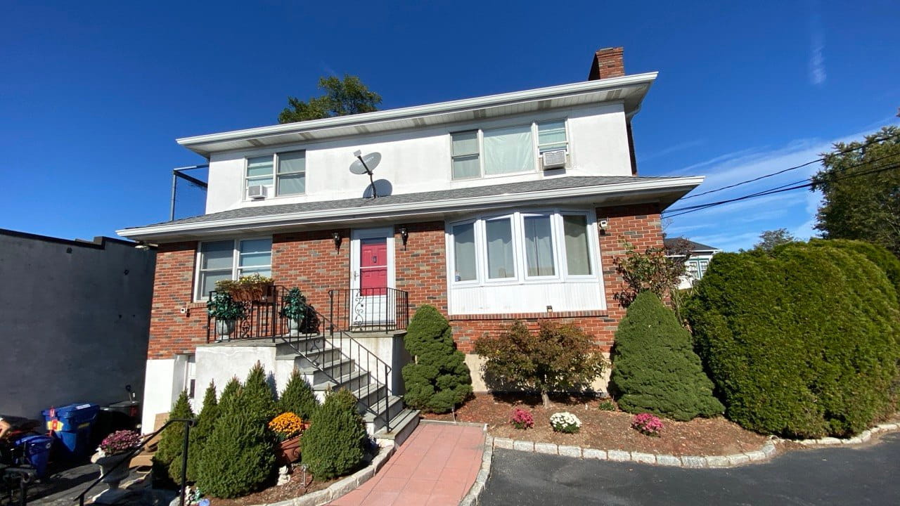 Gutter repair on two-story brick home
